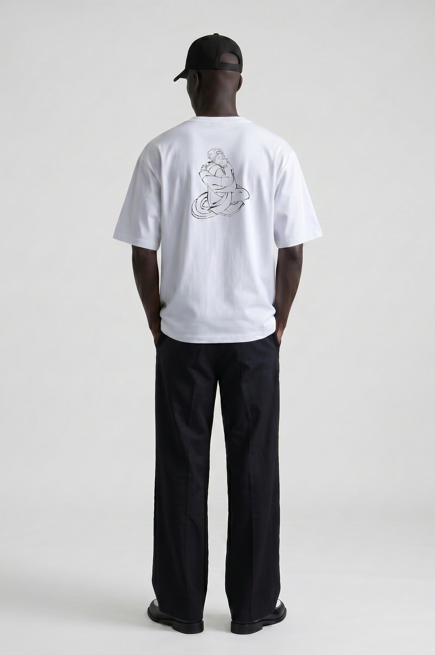 Model wearing the Hokusai Bond with Cats graphic T-shirt featuring Katsushika Hokusai's cat sketch.