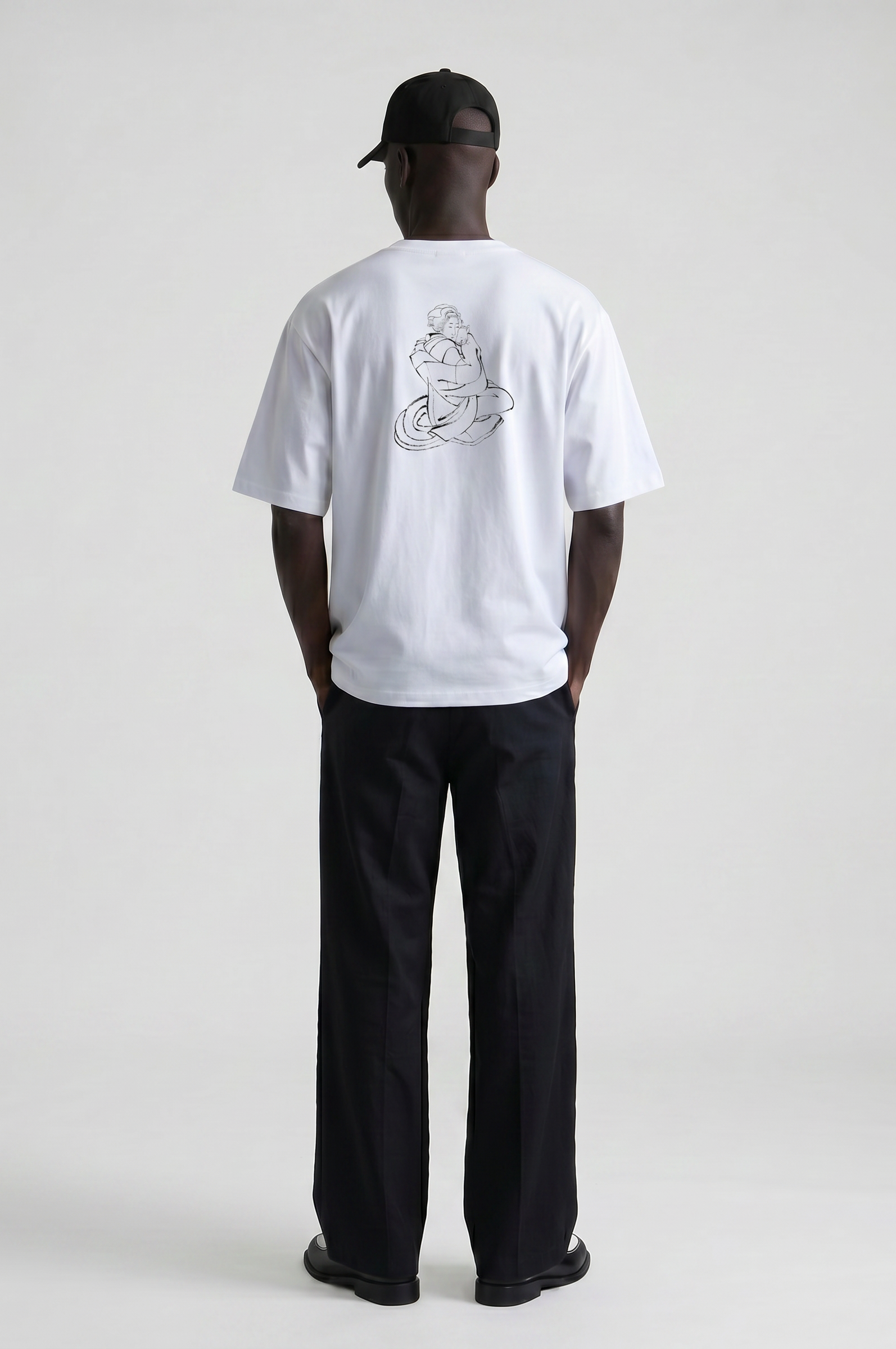 Model wearing the Hokusai Bond with Cats graphic T-shirt featuring Katsushika Hokusai's cat sketch.