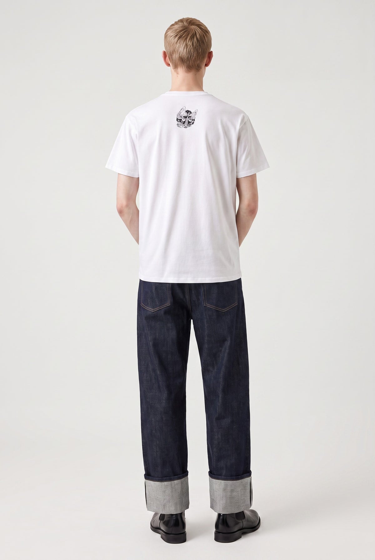 Model wearing a white T-shirt with a small Kawanabe Kyōsai cat illustration printed near the back collar.
