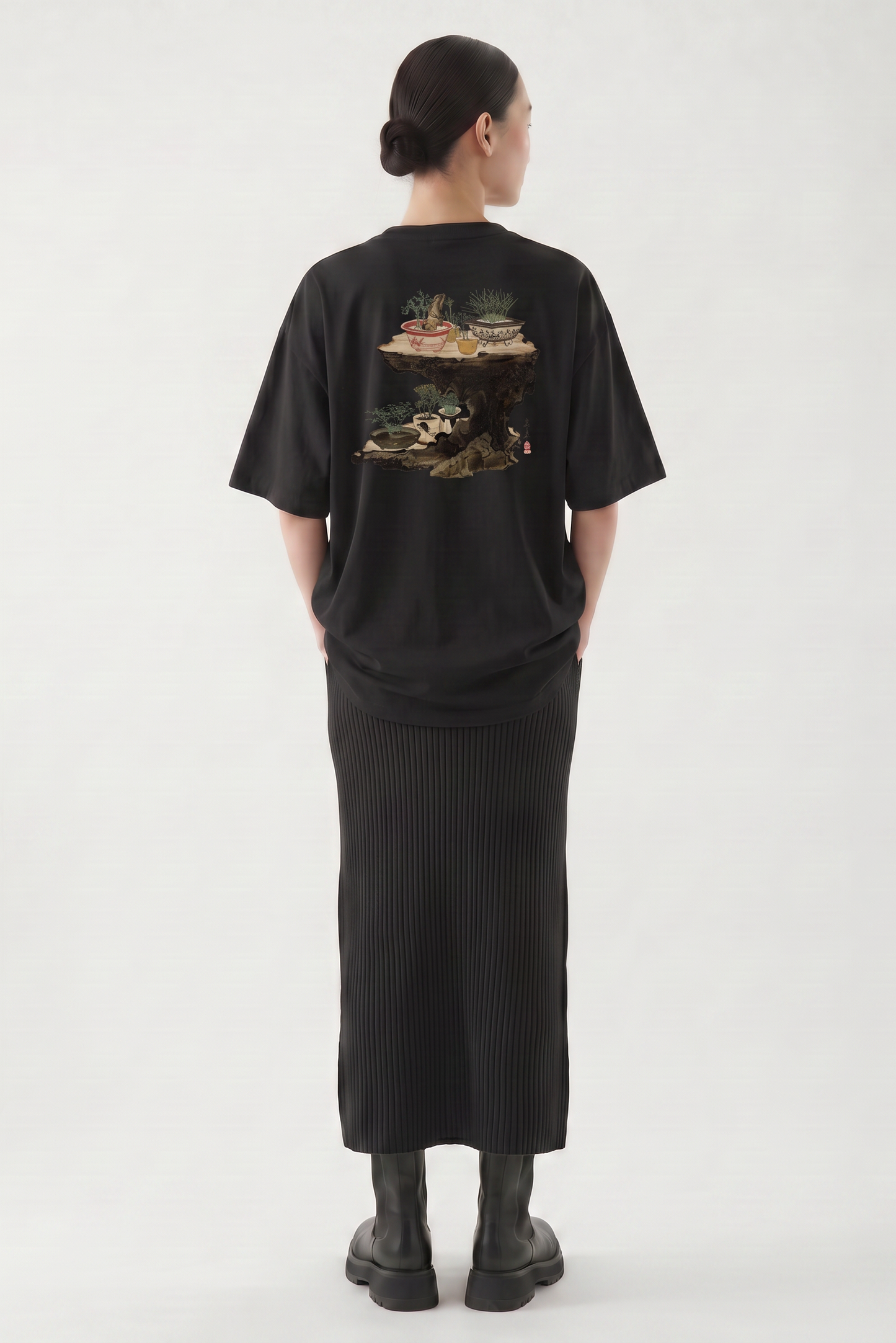 Model wearing a Shibata Zeshin bonsai graphic T-shirt inspired by traditional Japanese art and elegant bonsai illustrations.