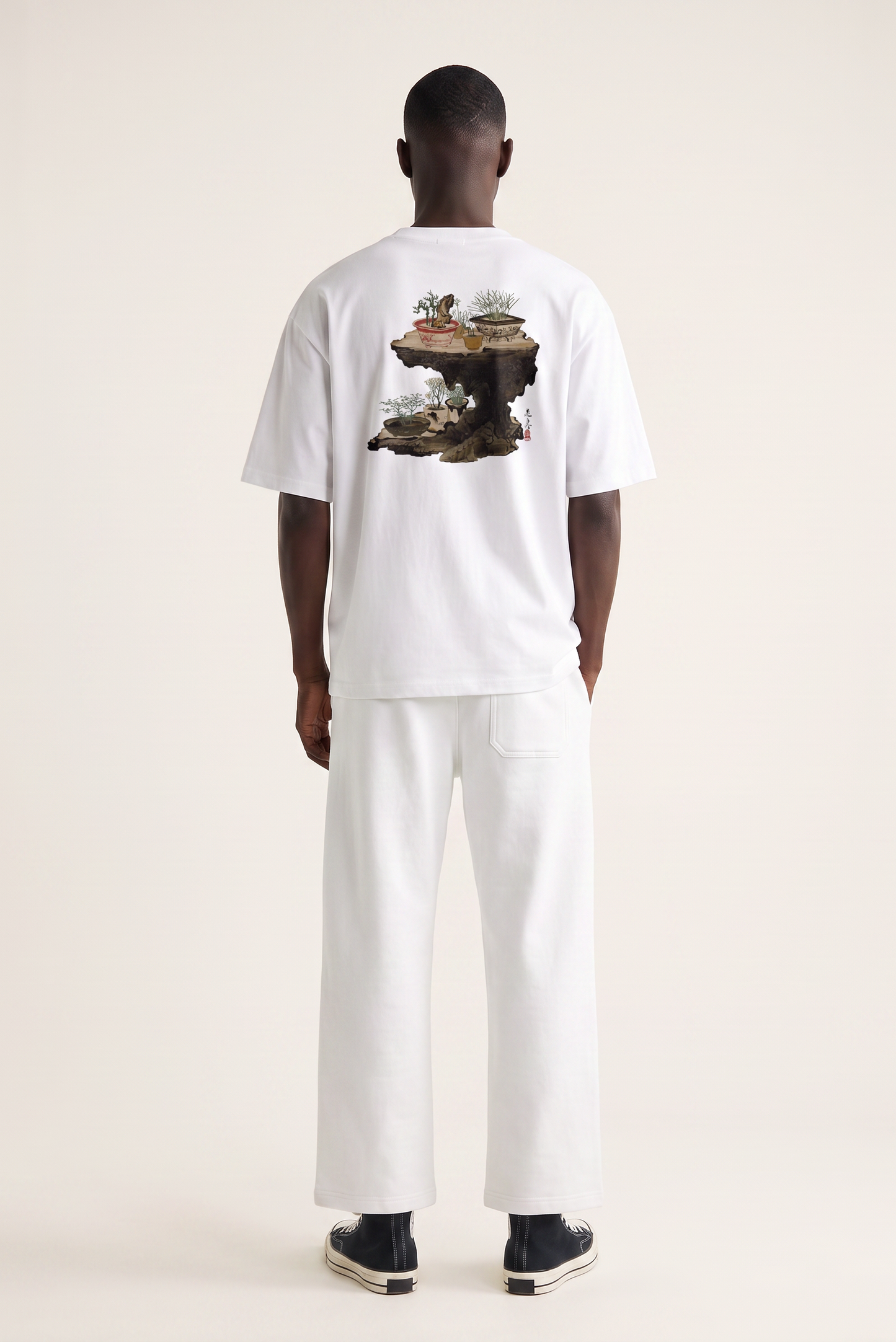 Model wearing a Shibata Zeshin bonsai graphic T-shirt inspired by traditional Japanese art and elegant bonsai illustrations.