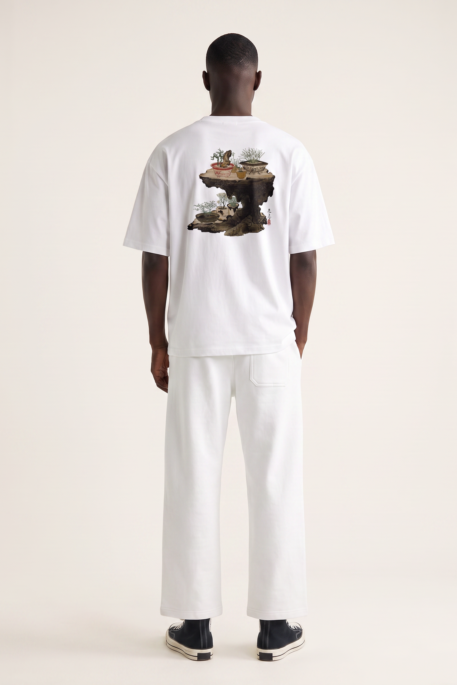 Model wearing a Shibata Zeshin bonsai graphic T-shirt inspired by traditional Japanese art and elegant bonsai illustrations.