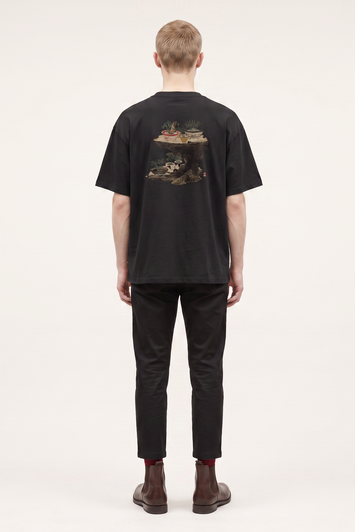 Model wearing a Shibata Zeshin bonsai graphic T-shirt inspired by traditional Japanese art and elegant bonsai illustrations.