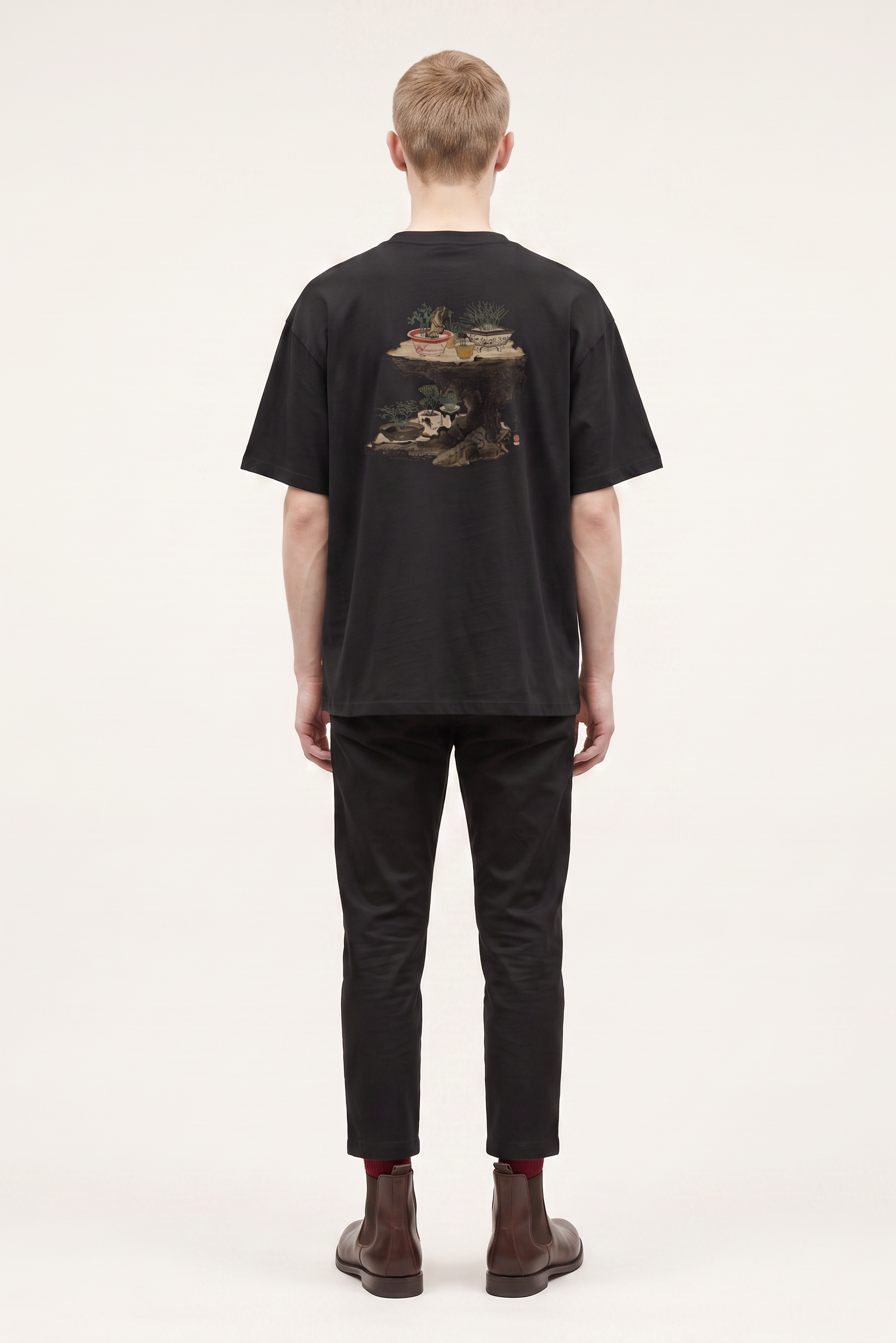 Model wearing a Shibata Zeshin bonsai graphic T-shirt inspired by traditional Japanese art and elegant bonsai illustrations.