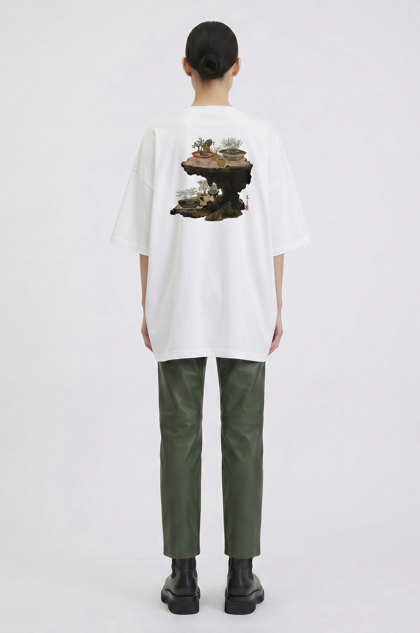 Model wearing a Shibata Zeshin bonsai graphic T-shirt inspired by traditional Japanese art and elegant bonsai illustrations.